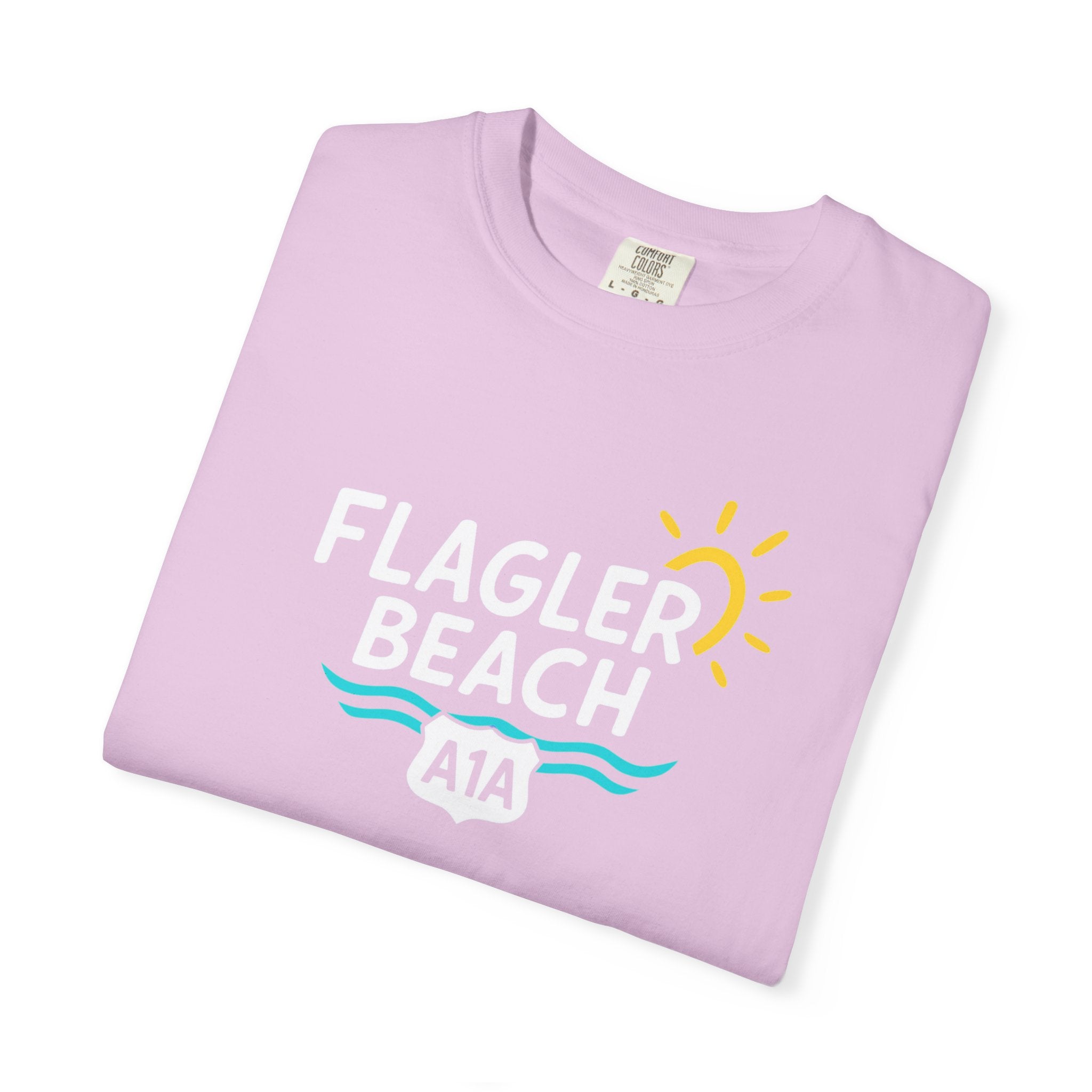 Folded light purple t-shirt with 'Flagler Beach A1A' text and graphics on a white background