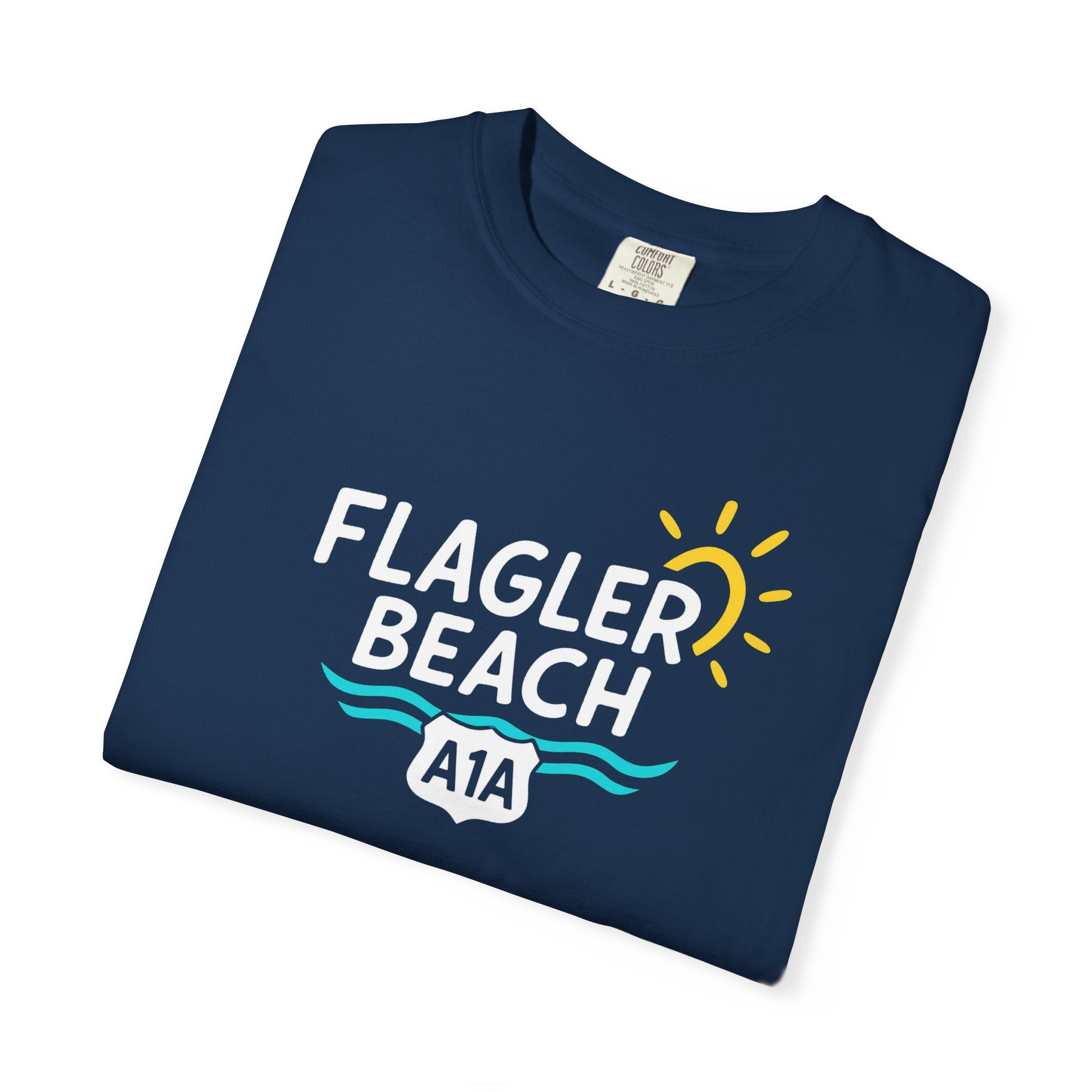 Folded navy blue t-shirt with 'Flagler Beach A1A' text and graphics on a white background