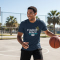 Man holding a basketball on a court wearing a 'Flagler Beach' t-shirt.