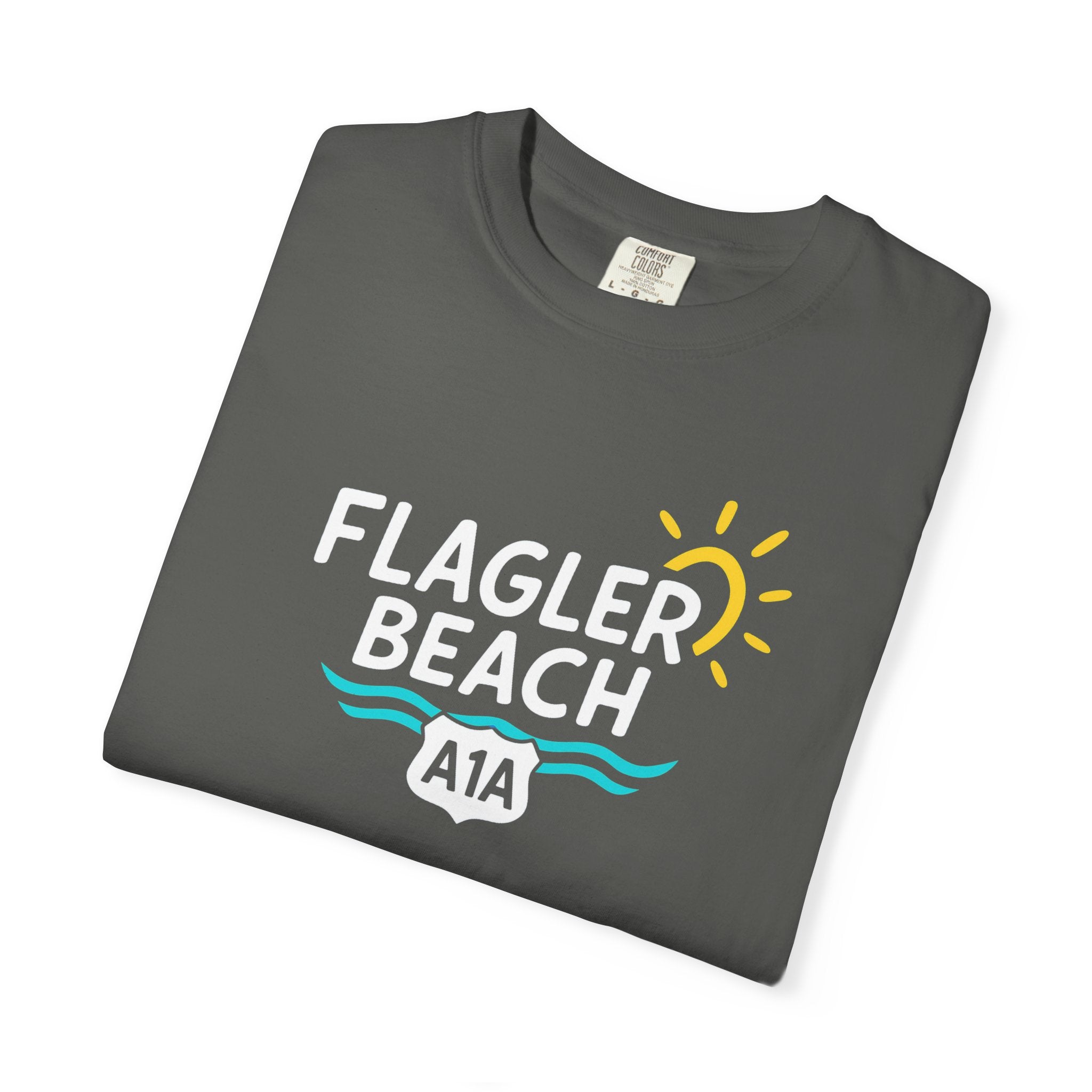 Folded gray t-shirt with 'Flagler Beach A1A' design on a white background